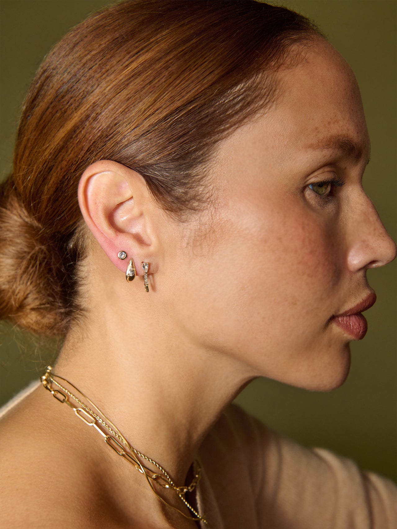 14kt Yellow Gold White Sapphire Bezel Stud pictured on model in third piercing. 