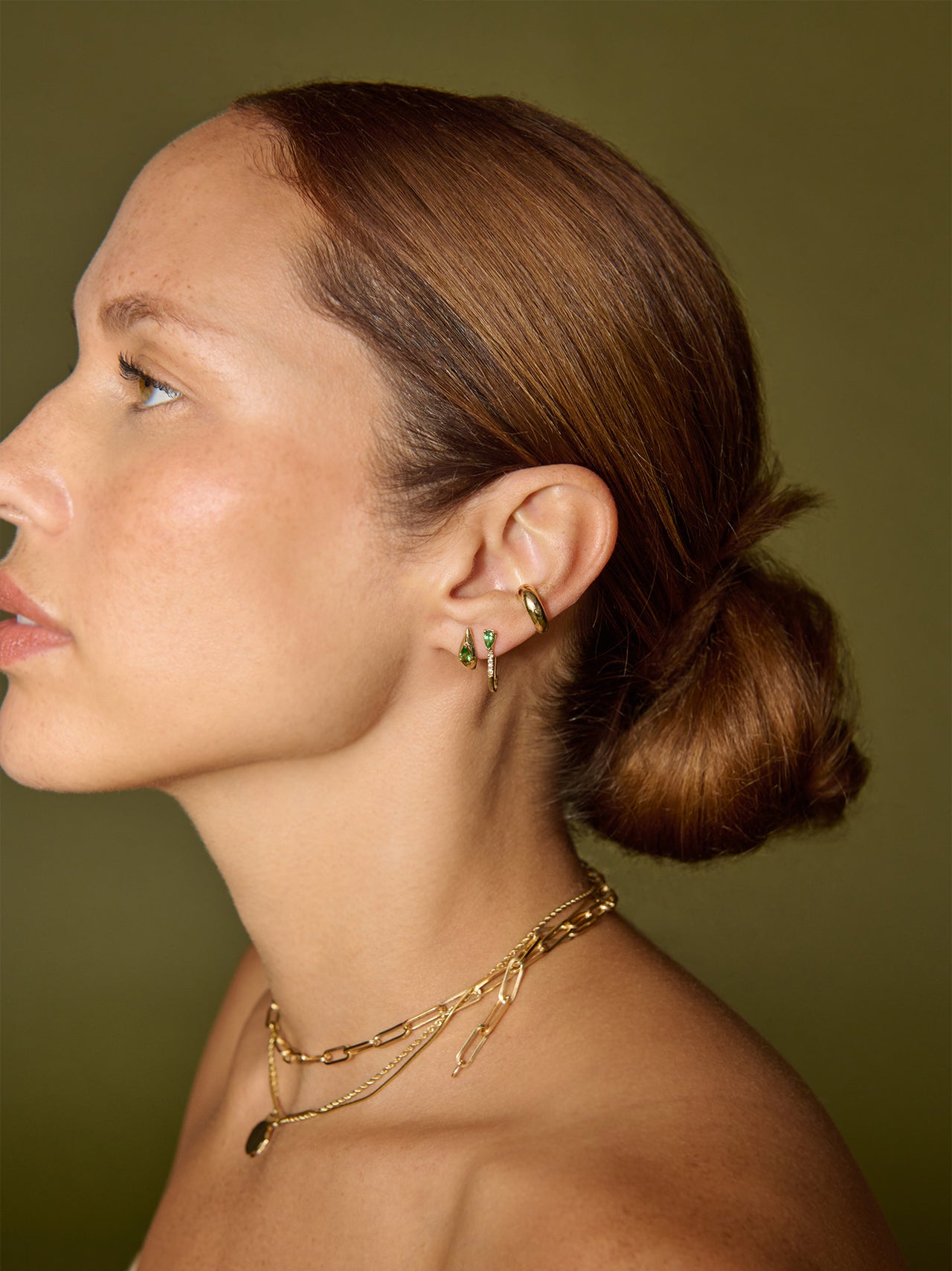 14kt Yellow Gold Mini Diamond Tsavorite Safety Pin pictured in models first piercing. 