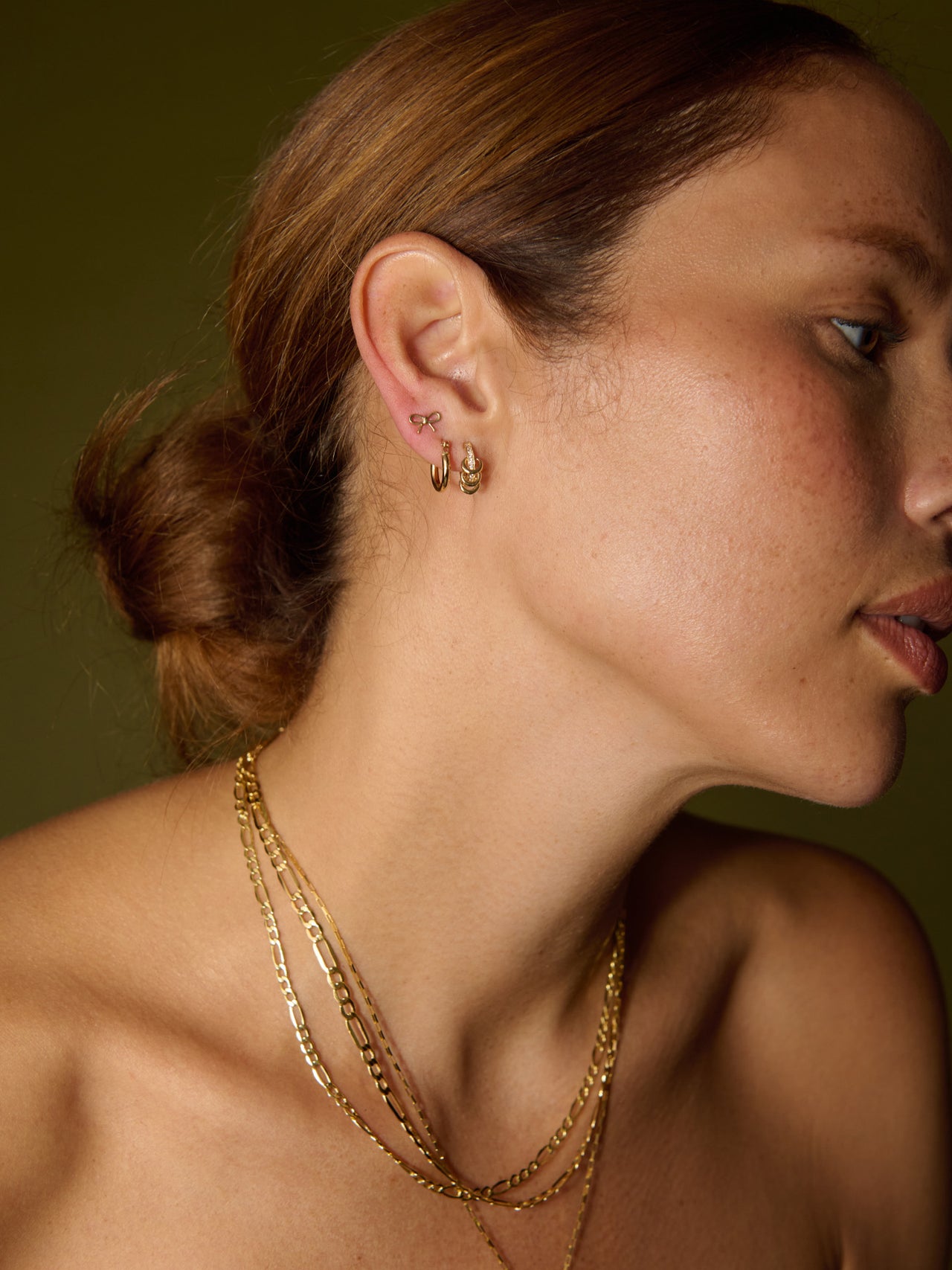 14Kt Yellow Gold XL Hollow Figaro Chain pictured on model. 