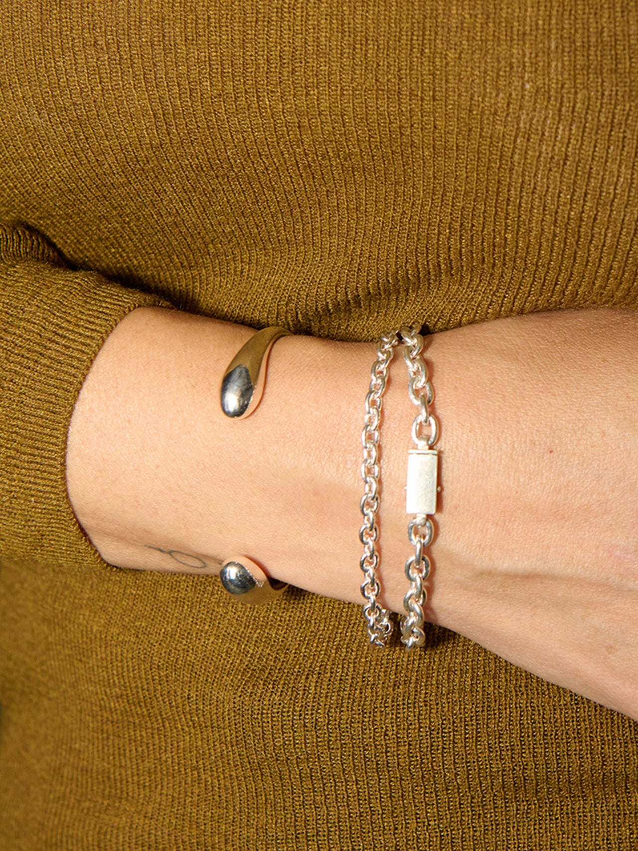 Sterling Silver Cable Chain Bracelet pictured on models wrist. 