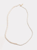 14kt Yellow Gold Graduated Pearl Necklace pictured on light grey background.