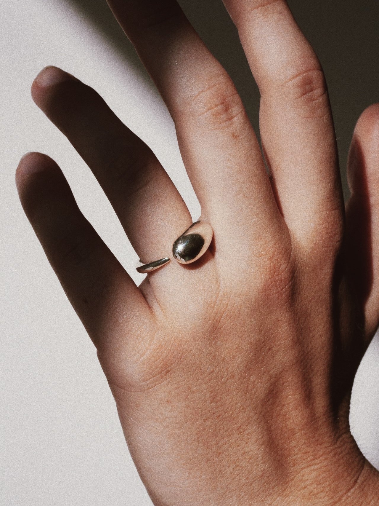 Ouroboros Ring pictured on models ring finger. 