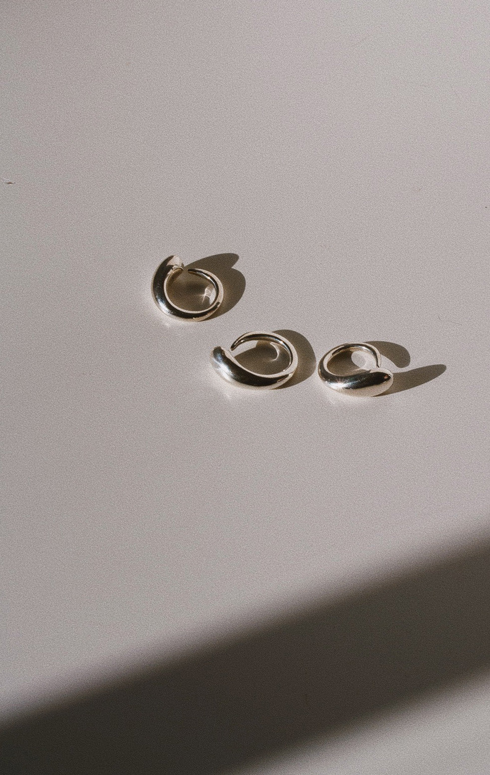 Three Ouroboros Rings pictured on light grey background. Ouroboros Ring 