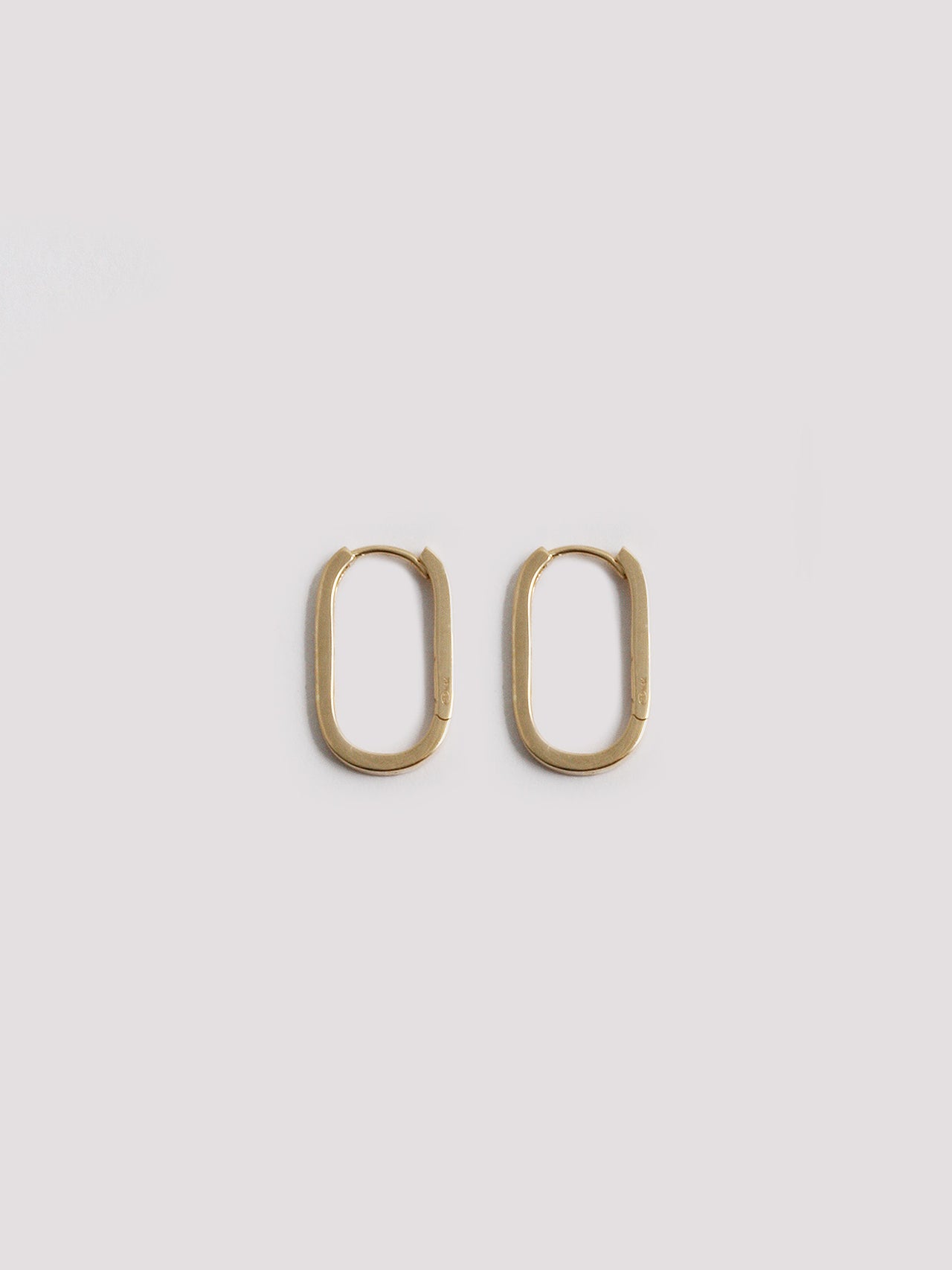 14kt Yellow Gold Paperclip Hoops pictured on light grey background.