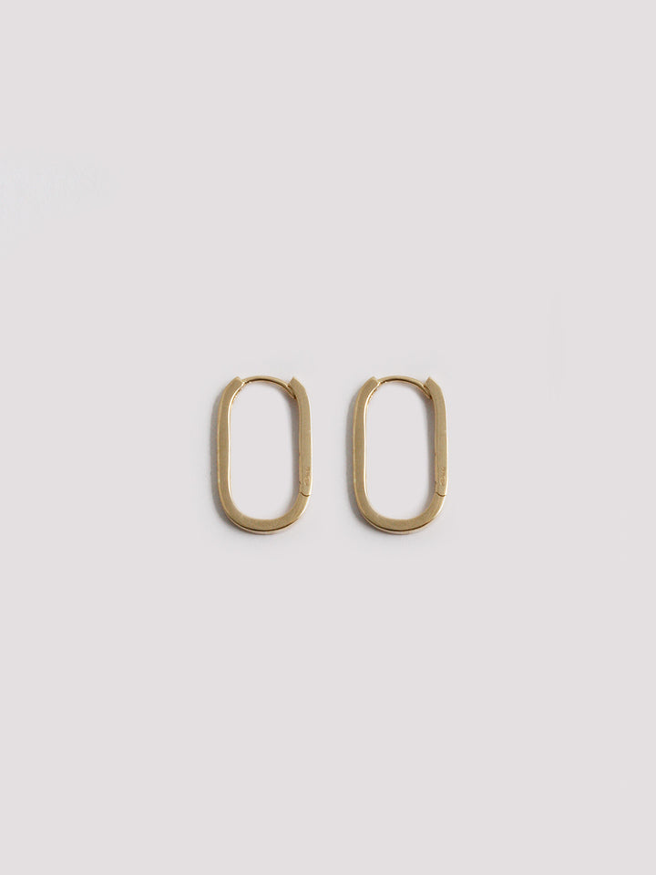 14kt Yellow Gold Paperclip Hoops pictured on light grey background.