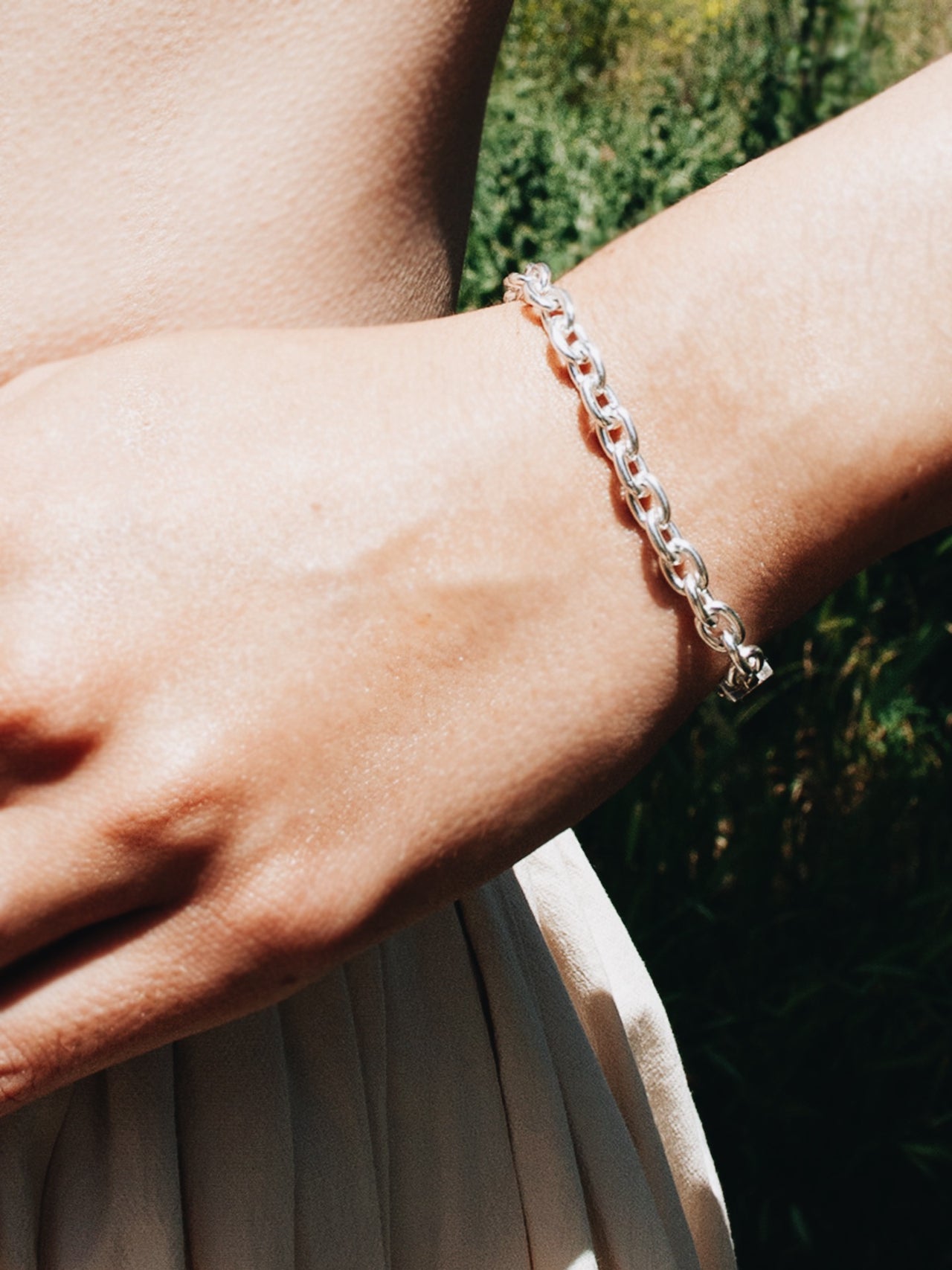 Sterling Silver Cable Chain Bracelet pictured on models wrist. 