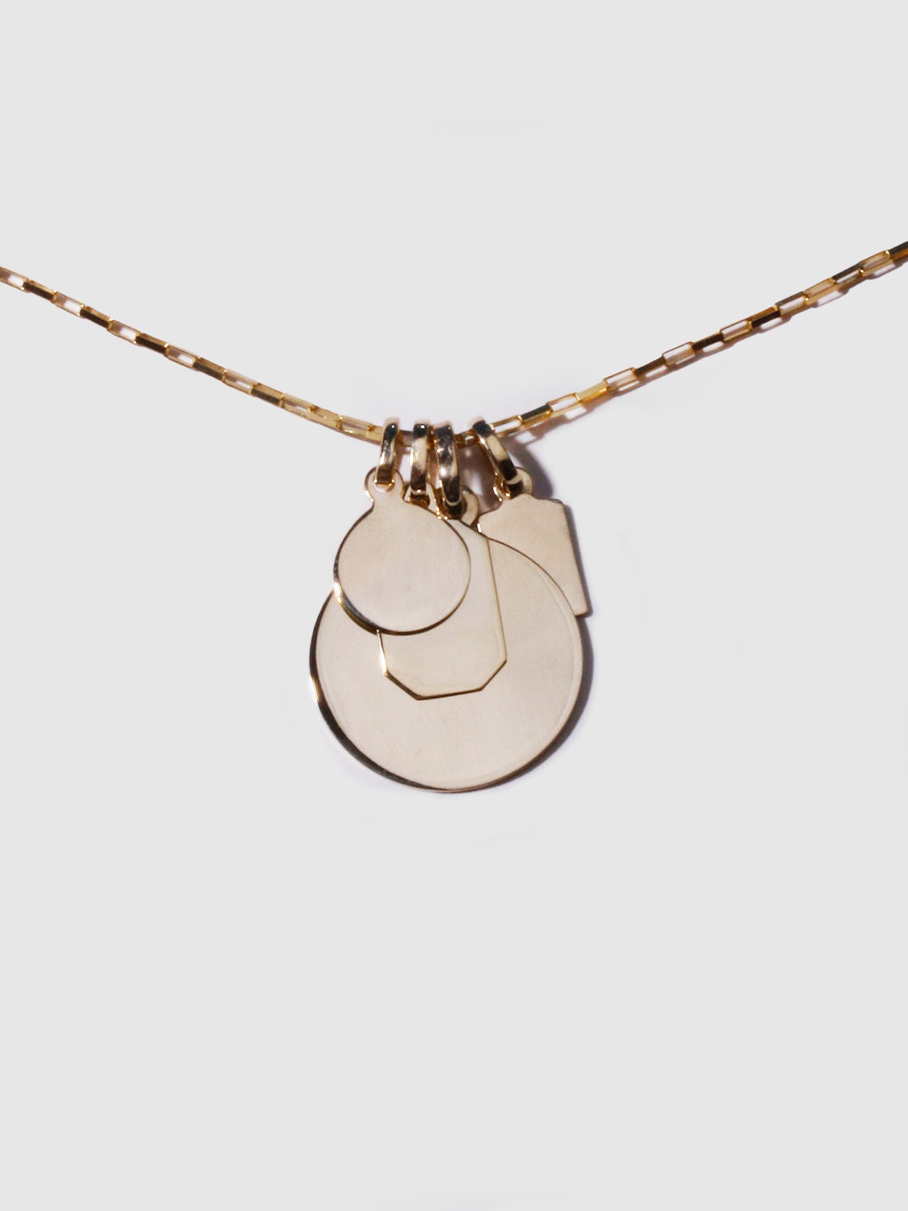 14Kt Yellow Gold Disk Pendant stacked with the Mini Disk , Octagonal ID and Klint ID Pendants.