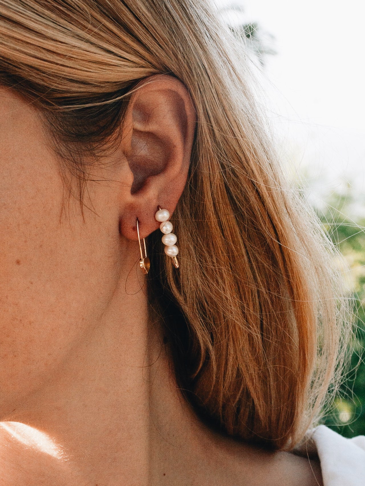 Heart Safety Pin Earring pictured in models first piercing. 