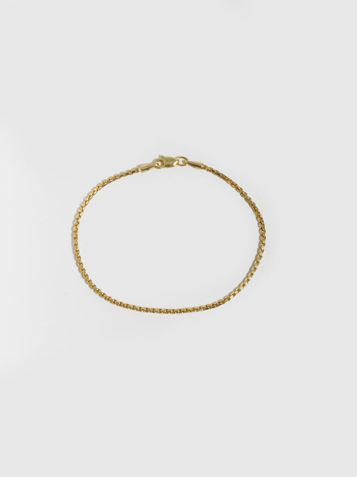 10kt Yellow Gold Squared Box Link Bracelet pictured on light grey background. 