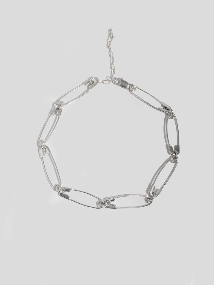 Sterling Silver Safety Pin Link Chain pictured on light grey background. 