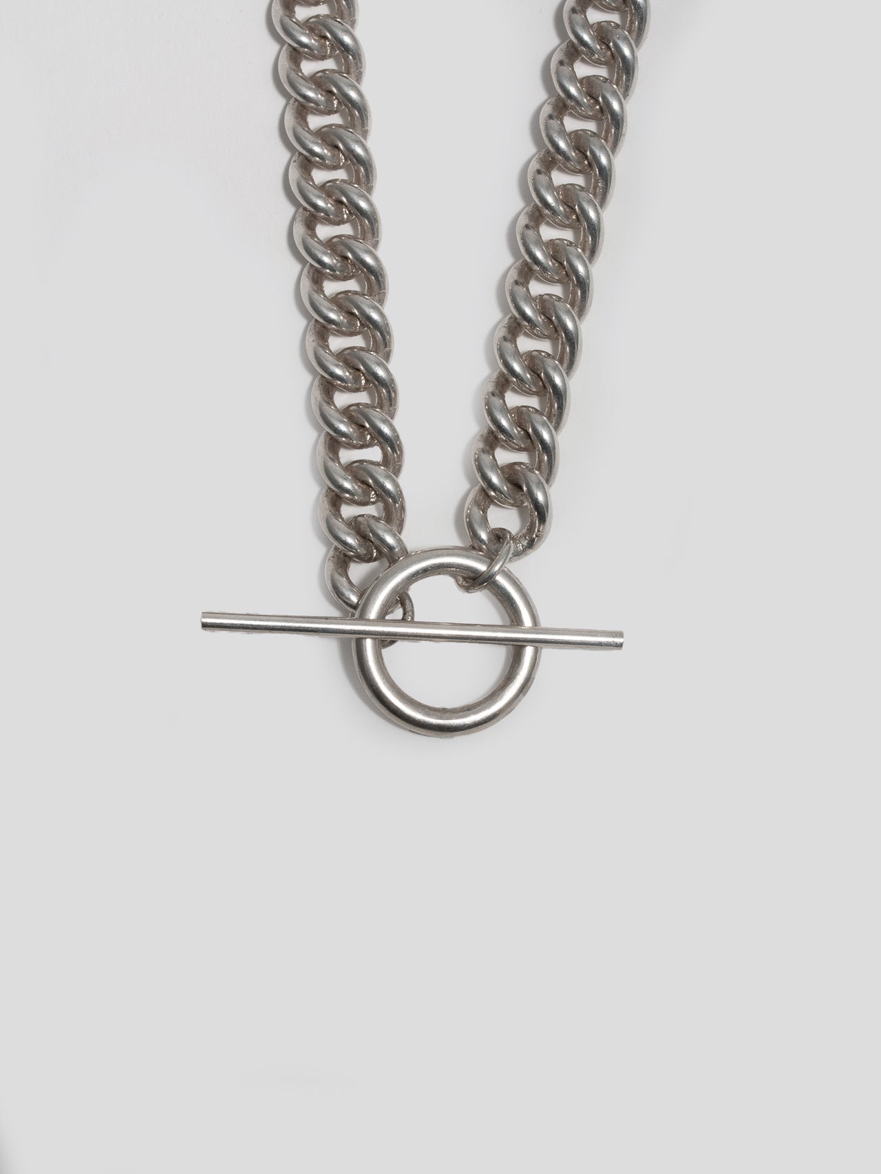 Sterling Silver Solid XL Industrial Curb &amp; Toggle Necklace pictured on light grey background. Close up of toggle closure.