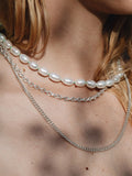 Sterling Silver Cable Chain pictured on model layered with other necklaces.