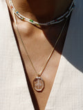 14kt Yellow Gold Box Weave Estelle Chain pictured on model with a pendant strung from it. 