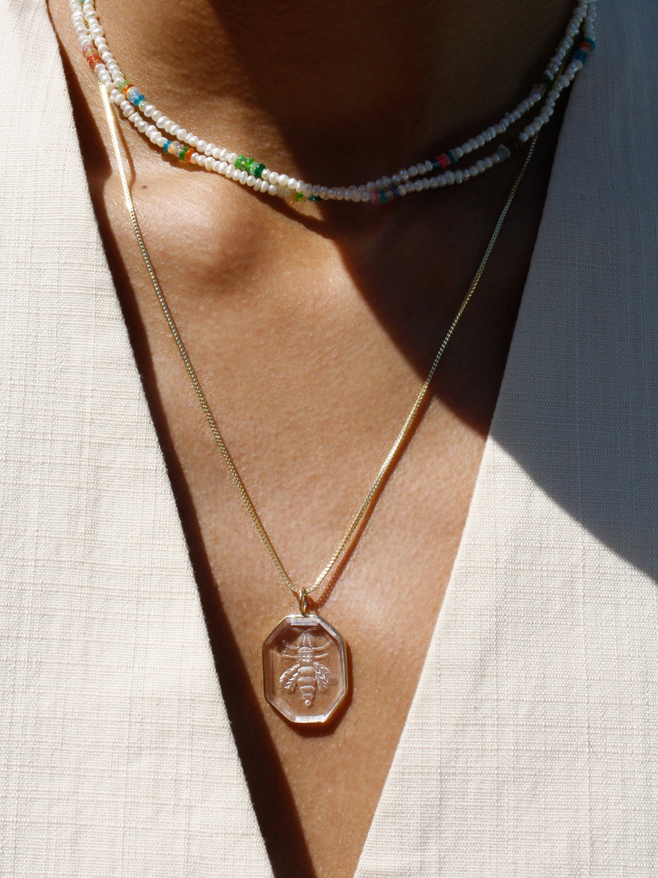 14kt Yellow Gold Box Weave Estelle Chain pictured on model with a pendant strung from it. 