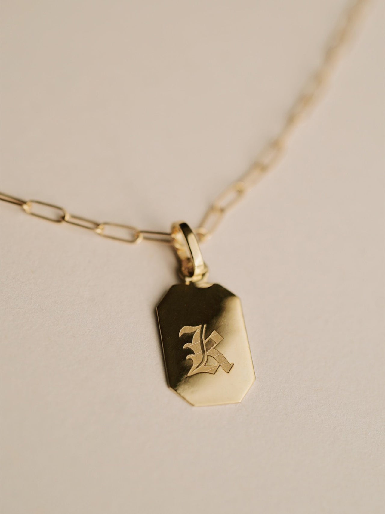 Octagonal ID Pendant engraved with K in Gothic Font.
