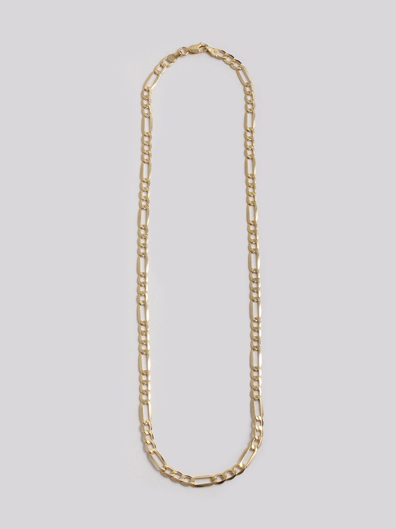 14KT Yellow Gold Figaro Chain shot on light grey background. 