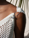 Jumbo Safety Pin used a garmet closure. Pictured on models shoulder. 