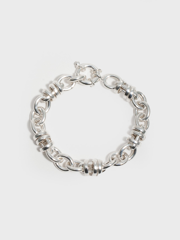 Sterling Silver Whorl Chain Bracelet pictured on light grey background. 
