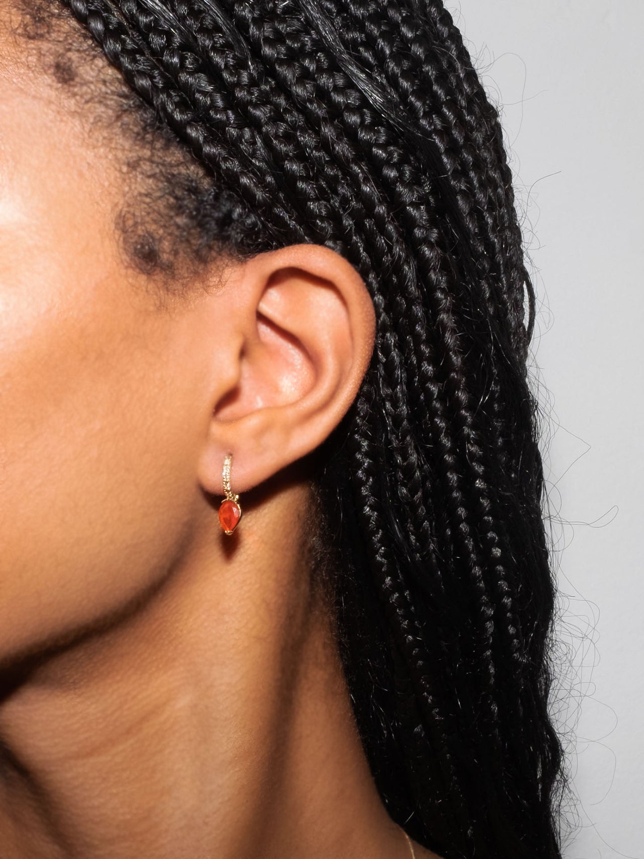 14kt Yellow Gold Diamond & Gem Hoop pictured in models ear. 