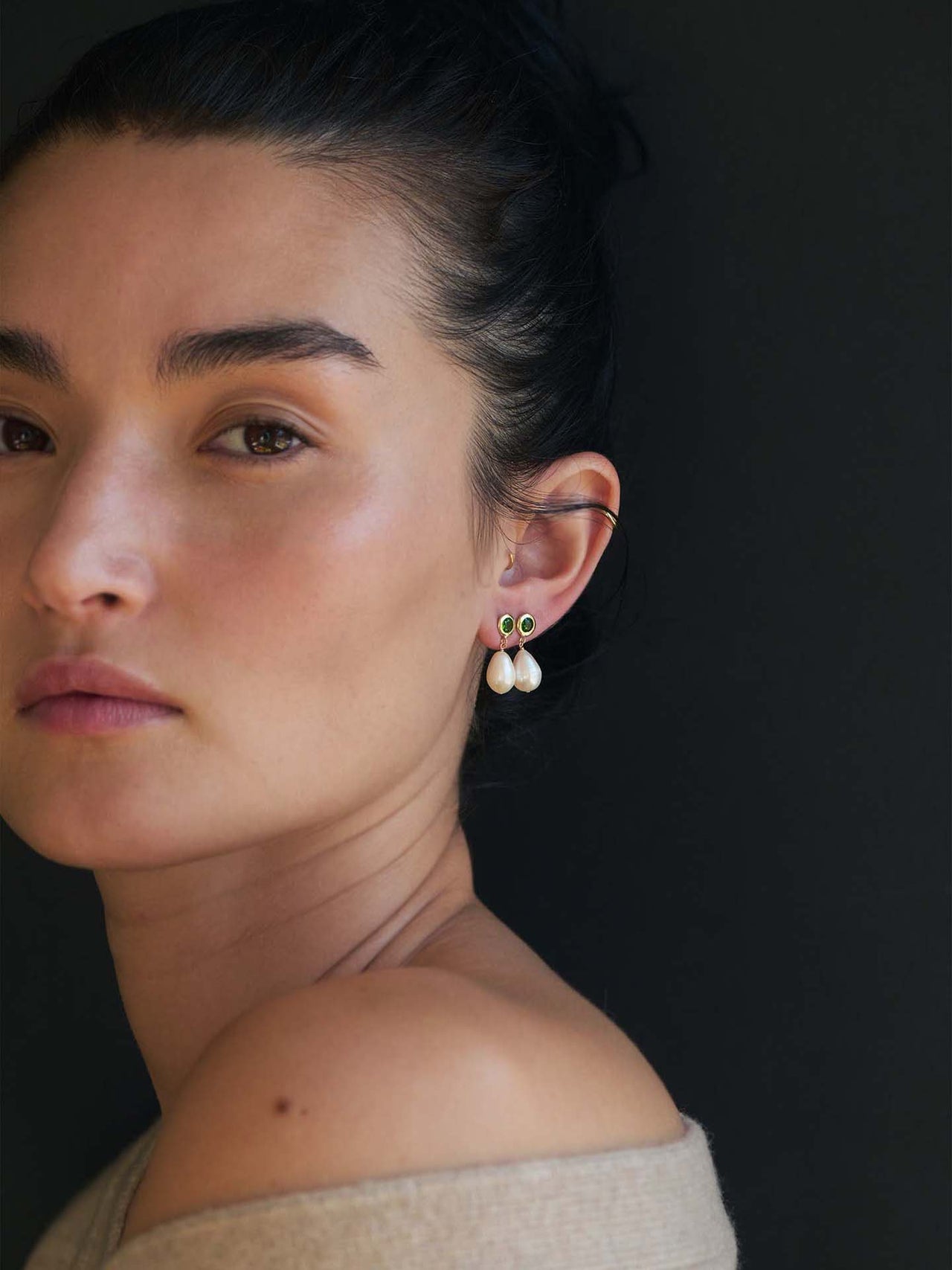 Tantra Pearl Link Earrings pictured on model.  Black background. 