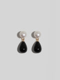 Daphne Onyx Earrings pictured on light grey background. 