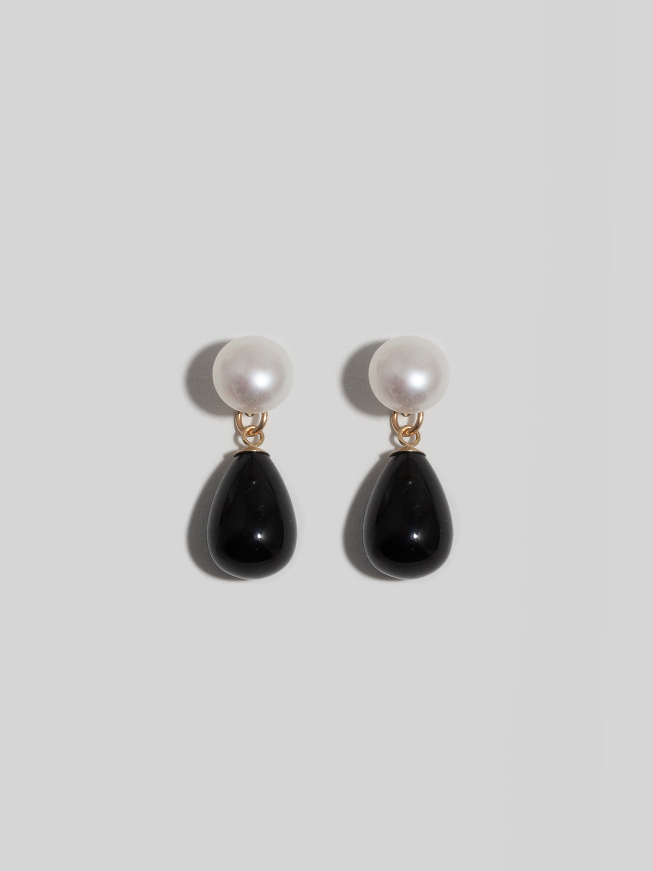 Daphne Onyx Earrings pictured on light grey background. 