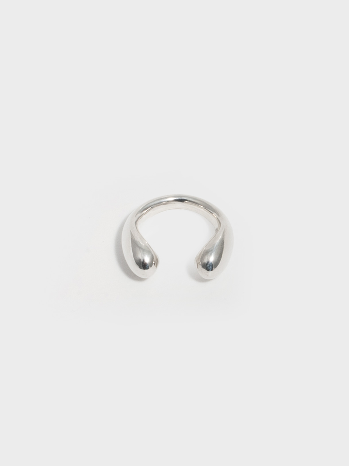 Sterling Silver Torque Ring on light grey background. 