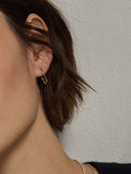 14kt Yellow Gold Paperclip Hoops pictured on model.