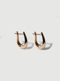 14kt Yellow Gold Cleopatra Huggies pictured standing up right on light grey background. 