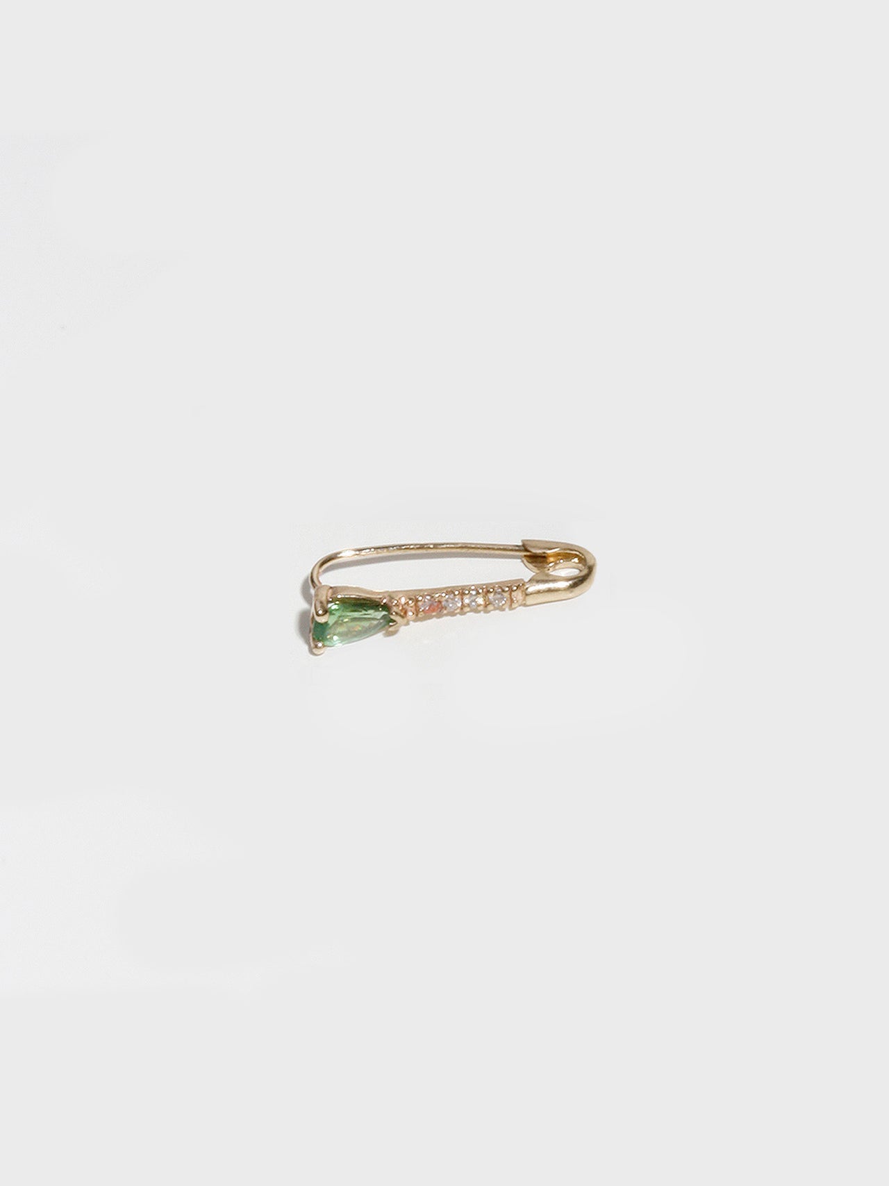 14kt Yellow Gold Mini Diamond Tsavorite Safety Pin pictured on light grey background.
