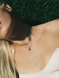 On model image of  the Blitz Collar (Vermeil RX Chain Width: 6mm  Thickness: 2.2mm Length: 15.25’’) along  with other styles Background: greenery