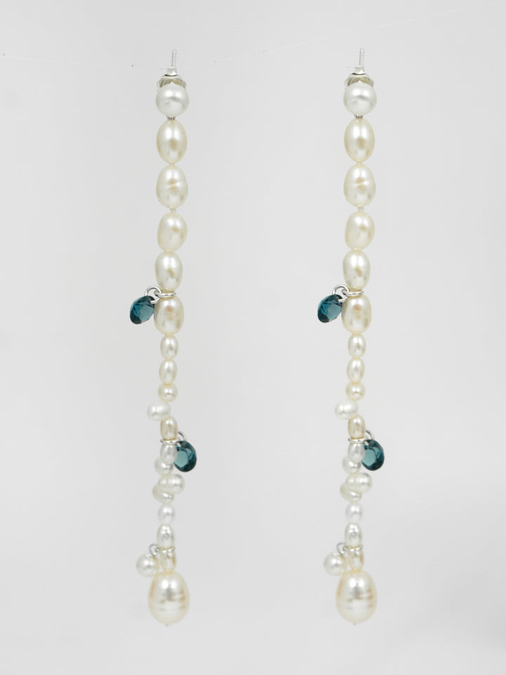 Satellite Pearl Earrings shot on Light Grey background. Mixed white pearls, blue london topaz gemstones.