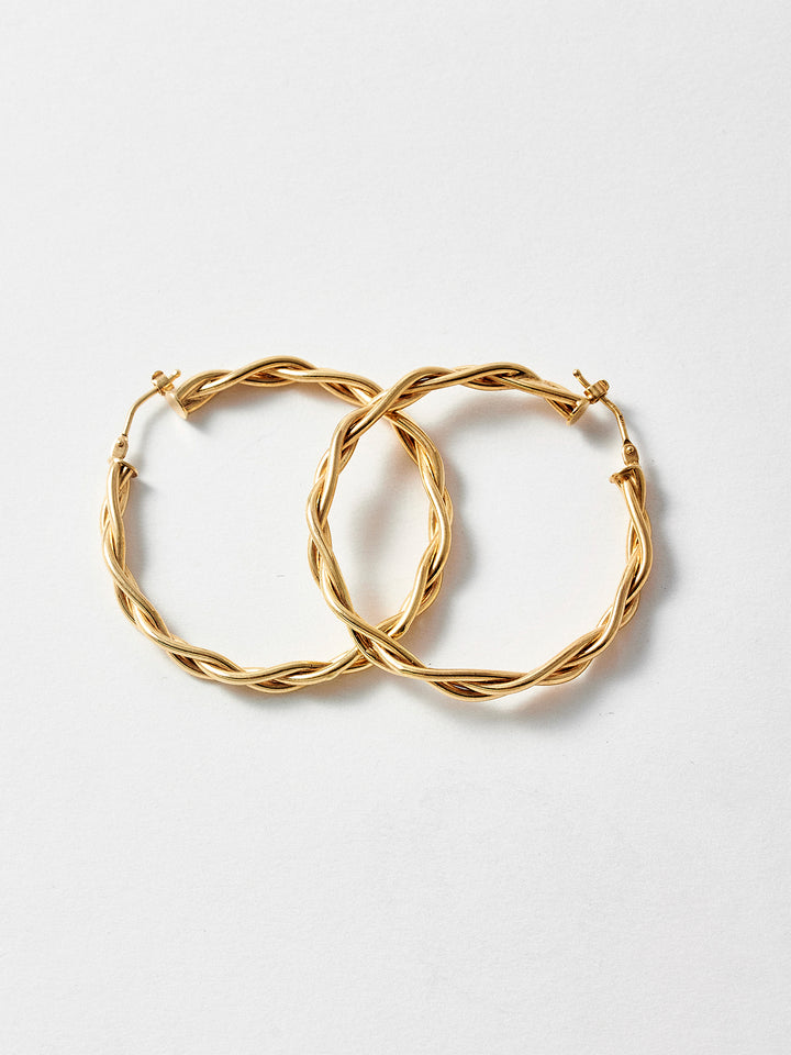 Styled product shot of the Braided Hoops (Vermeil Braided Hoops Diameter: 40mm Thickness: 4mm) Background: Grey backdrop